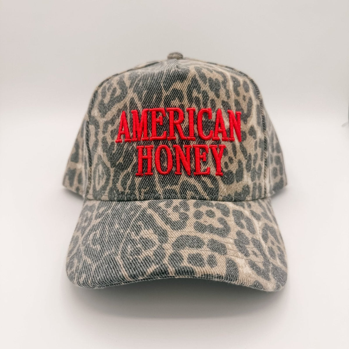 Leopard print cap with 'American Honey' text on a white background