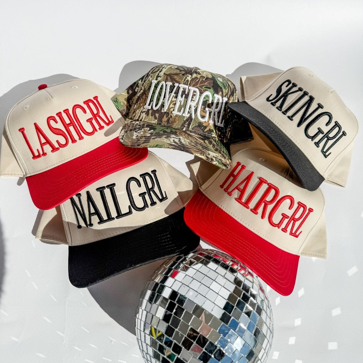 Four hats with text labels on a white background with a disco ball.