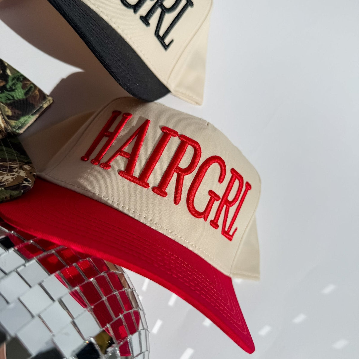 Three hats with different designs and text on a white background