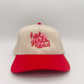 Beige and red cap with 'hot girls read' text on a light gray background